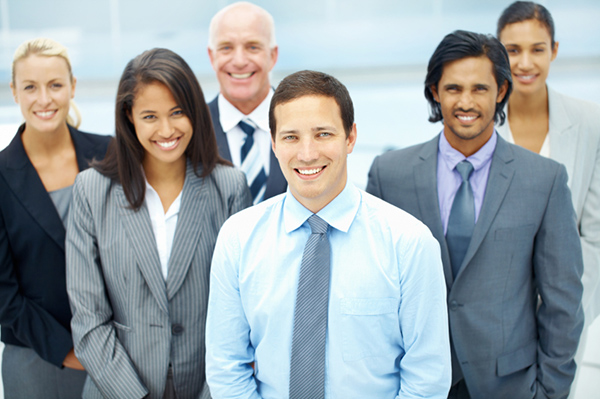 A group of successful and satisfied businesspeople looking upwards smiling